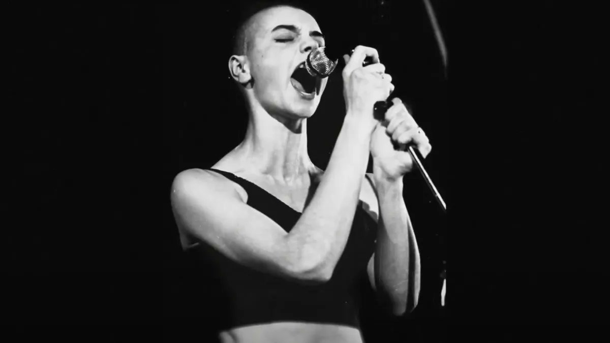 consequence's tweet image. Across 10 albums, Sinéad O’Connor never stopped wrestling with a sense of belonging, from the interconnectedness of lovers to the group politics of nations and religions → cons.lv/DnRVzw