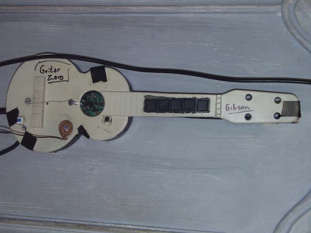 When I discovered that GH1 and GH2 games know that there is a guitar connected just pressing LEFT on the controller i made one myself back in 2007 padhacking a ps2 controller. Funny thing is the strumming method. Touch the wire with the (metal) pick.