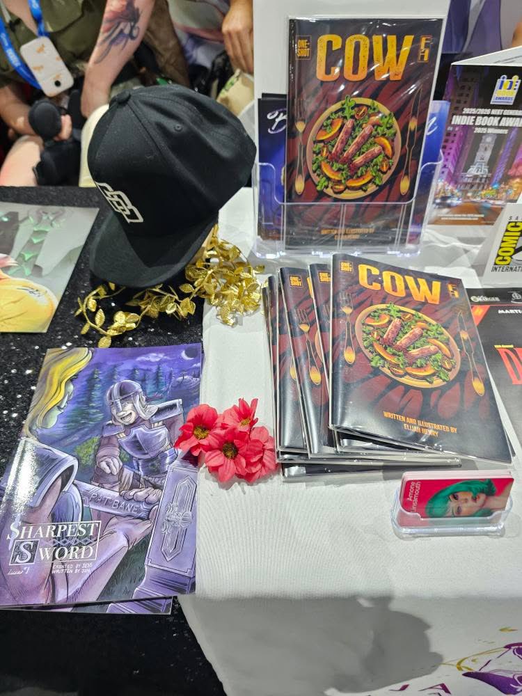 HollanderCooper's tweet image. Just found out that the first issue of Sharpest Sword (my comic!) took a trip to #SanDiegoComicCon!
If you’re around check it out at table H-10 (and big shout-out to @AmyLinsamouth for bringing it to the show).