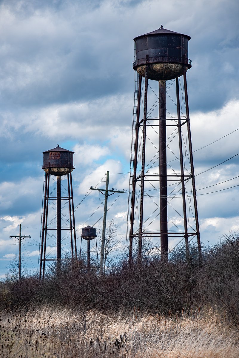 ExploresMr's tweet image. These water towers act as moody sentinels against an autumn sky at an abandoned Pennsylvanian World War II ordnance plant.