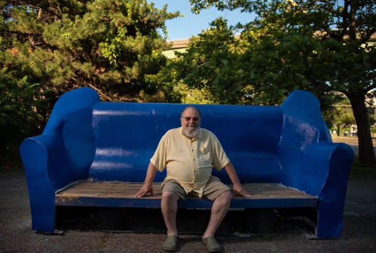 The other day, as sculptor Angelo Puccia worked on restoring giant ‘couch’ - his longtime street art welcome in shadow of interstates - man living on streets told Puccia how he often sleeps on sculpture. He wanted to help with project: Puccia, deeply moved, hired him on the spot.