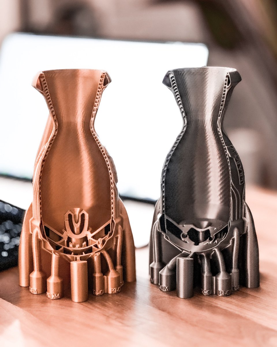 leap_71's tweet image. Two compact monolithic 2kN KeroLOX thrusters generated by Noyron. On the left a version with Pintle, on the right an impinging injector. Noyron allows us to quickly swap out the engineering logic and test different variants without manual work.