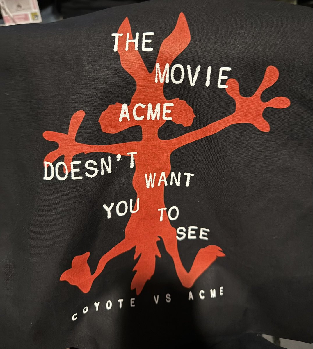 LeonBrill's tweet image. Coyote vs Acme taking shots at Warner Bros. & David Zaslav with their #SDCC25 Hall H merch