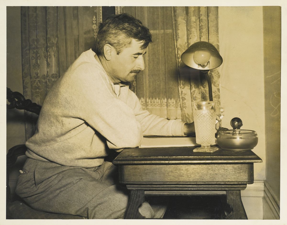 William Faulkner at his writing desk.