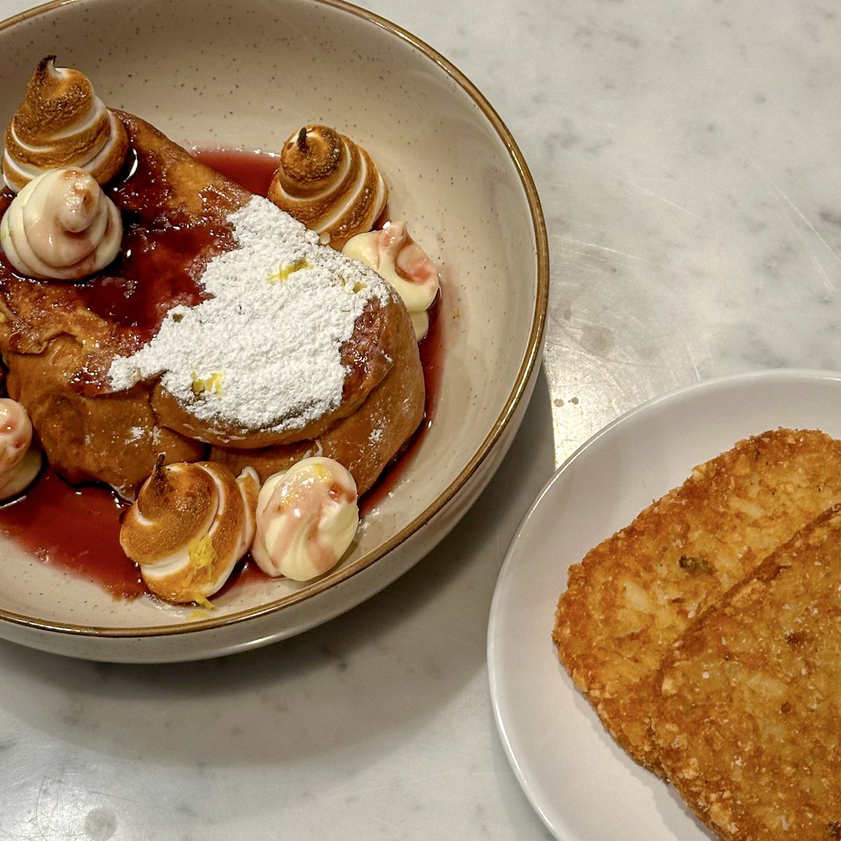 HoeannaNewsom's tweet image. Challah French toast with lemon marscapone cream, toasted meringue, berry syrup, and of course some fried hash brown patties for my growing boy