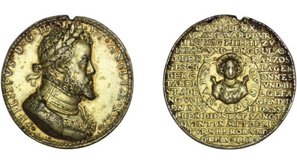 Medal marking a victory of Philip “King of Spain &amp; England” over the French on 10 Aug 1557. 
It also marks the taking &amp; plunder of St Quentin 27 Aug 1557, hence the image of the saint on the obverse.

(British Museum: M.6852)