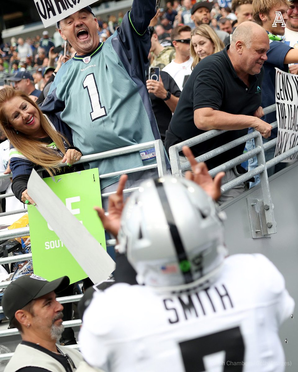 TheAthletic's tweet photo. Raiders QB Geno Smith and edge Maxx Crosby were caught on camera flipping off Seahawks fans on Thursday.

Smith's gesture was in response to a fan appearing to say something toward Smith. The fan also had a sign that read “Bigger Bust — Geno Or Jamarcus Russell?” https://t.co/yX23Tpib6d
