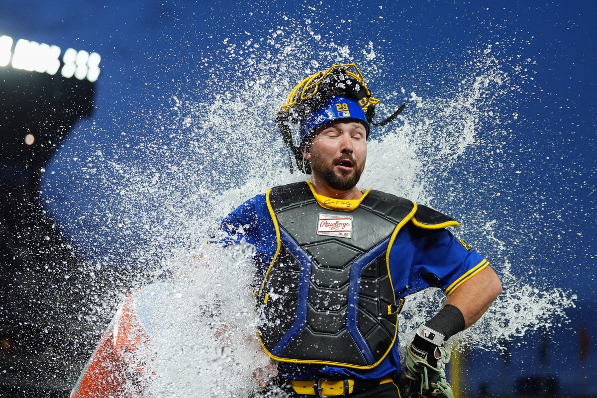Seattle #Mariners catcher Cal Raleigh reacts to being doused by teammate Victor Robles to celebrate a win over the Tampa Bay Rays on Friday. (AP/Lindsey Wasson)