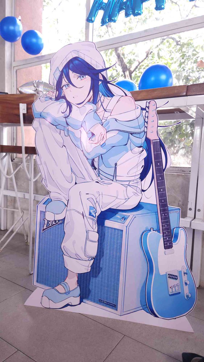 (got sent some photos of the standee at the event! it's really cool to see my art printed like this. i'll post the full art on the 11th but for now you can see it here 🎸✨)