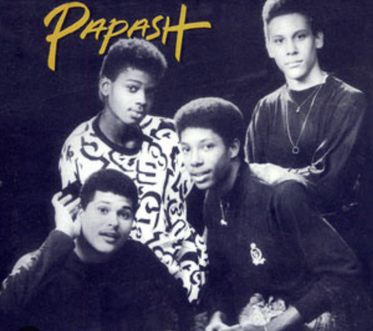 "Do you know this is one of the iconic compas bands from the late 1990s? If you know them, what is the name of the guy dressed in black and white .?