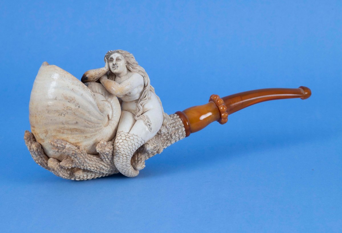 archaeologyart's tweet image. Large meerschaum pipe with its original amber stem, carved as a mermaid embracing a nautilus-shell bowl; Vienna, c. 1880 AD. Collection: Hyland Granby Antiques. Dimensions: H 3¾ in, L 9 in, D 2⅛ in.