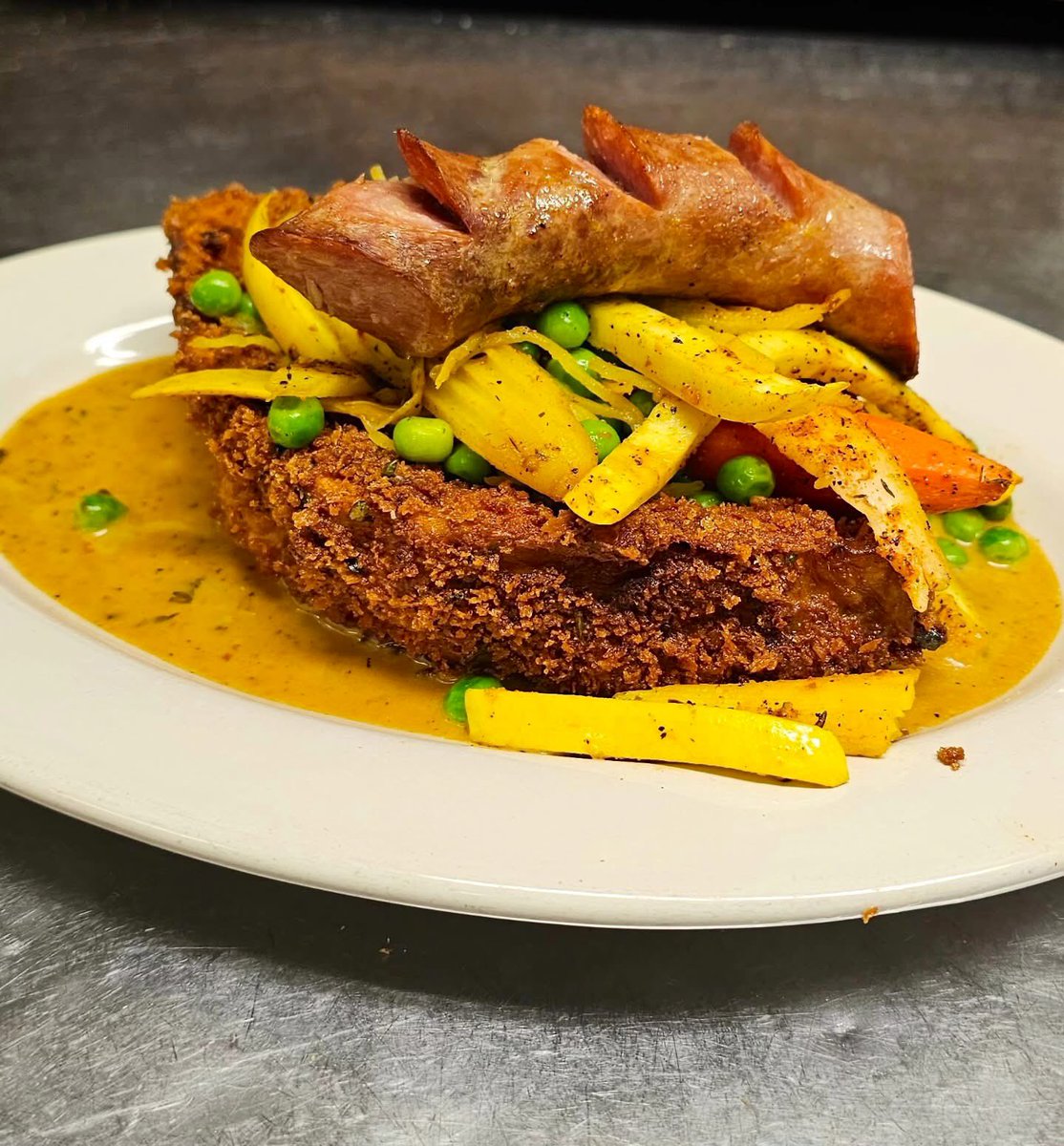 It's COOLinary time! Come in during the month of August and enjoy dishes like this Fried Eggplant Pirogue with summer vegetables, lemon butter sauce, and topped with smoked andouille as part of a 3 course meal for $56 per person. Reservations available on <a href="/resy/">Resy</a> or call
