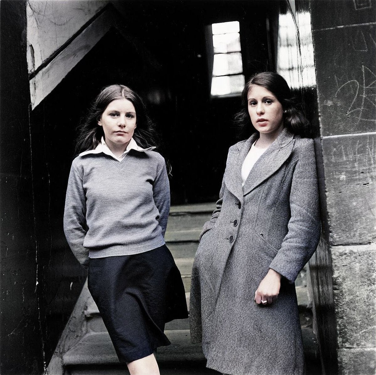 Two Girls Standing At The Entrance To  Close In A Street In Maryhill, Glasgow 1979
To View More Great Old Photos Of Old Glasgow, Visit Our Website At OldGlasgow.com