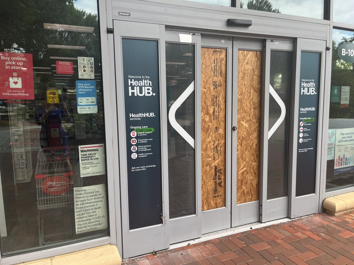 Glass doors at the CVS at Emory Point are boarded up and the store is closed following yesterdays shooting that killed Dekalb County Police Officer David Rose <a href="/FOX5Atlanta/">FOX 5 Atlanta</a>