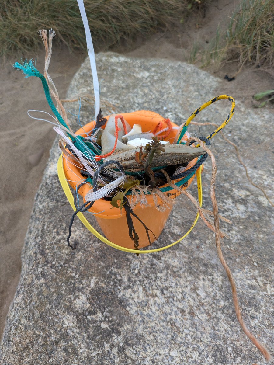 Cleaning up a beach at widemouth bay Cornwall