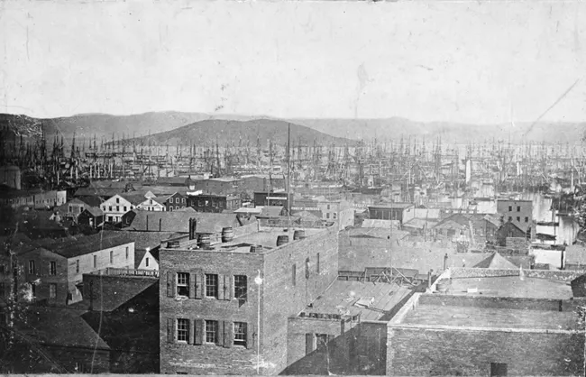 pitdesi's tweet photo. The Embarcadero & FiDi are built on top of ships that were abandoned in the 1849 gold rush - people were so eager to strike it rich that they abandoned their ships and headed for the hills... and the rubble was used to fill in the land. They are still finding ships buried there. 

In 1848, San Francisco was a dusty town of 800 people. Gold was discovered that year, but word spread slowly, until an enterprising man named Sam Brannan changed everything.

He bought up every pick, shovel, and pan he could find, then ran through the streets shouting, “Gold! Gold on the American River!”

He sold 20-cent pans for $15 (~$500 today) and became California’s first millionaire, without mining a single ounce of gold.

We owe him for the “picks and shovels” metaphor we use in startups today: in a gold rush, sell tools.

At the end of 1848, President Polk confirmed the discovery to Congress, and newspapers across the world picked up the story. This set off the gold rush. People came from the East Coast, Australia, China, and Europe, all in search of fortune.

By 1851, San Francisco had grown to 25,000 people. There were over 800 ships abandoned as people went to the hills as soon as they landed in search of their gold. They called it the “forest of masts.”

Folks who stayed behind made use of what was left behind- the ships. Many hulls became hotels, storeships, saloons, and even a jail. As the city filled in Yerba Buena Cove to create new land (you can see the original waterline in yellow in the map), these ships were buried beneath the streets of what’s now the Financial District.

Builders still uncover timbers, anchors, and gold rush artifacts during excavations. One of the most famous ships, the Niantic, was beached in 1849 and turned into a hotel and warehouse. Its remains are still buried at the corner of Clay and Sansome near the Transamerica Pyramid.

When the pyramid was being built, excavators uncovered more of the Niantic, along with an full intact case of Jacquesson & Fils champagne from 1849... now on display at the maritime museum. I think they should auction off one of the bottles. Jacquesson is still producing champagne today.

Fun fact: the company that created Pokemon Go is a Google spinoff called Niantic... named after the ship. Founder John Hanke was inspired by the idea that just like the Niantic is buried beneath the city, the world around us is full of hidden layers and stories-- if you know where to look. That became the company’s mission: build AR games that uncover layers in the real world.

The Old Ship Saloon (across from the Battery), was built on the hull of the Arkansas, which wrecked on the original shoreline. It opened in 1851 and is the oldest bar in the West.
Parts of the Muni go through ships too - the N, K, and T lines run through the hull of The Rome - it didn't make sense to move it when they built the muni line.

If you know other lore I should write about please share!