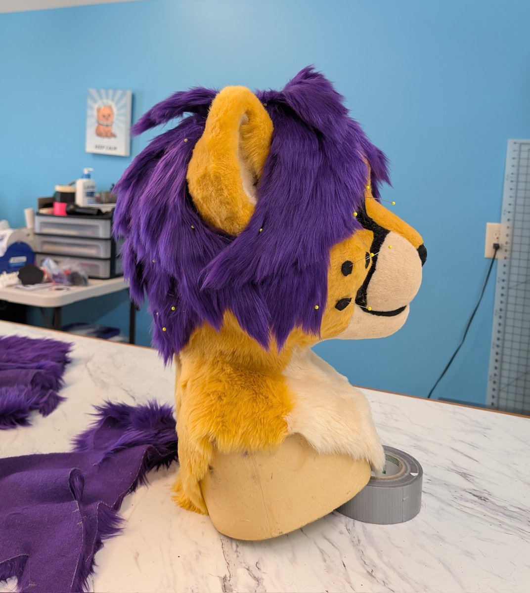 The hair is all pinned on and now I'm hand sewing it down. :D In the end it'll look cleaner after getting a final trim and some airbrushing, but it's looking good so far.

Base used is my large toony feline, link in bio~

#fursuit