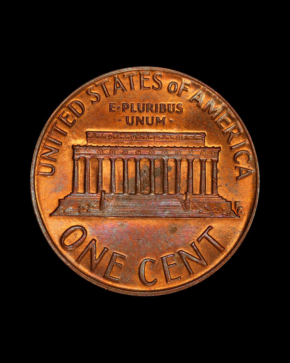 This Lincoln Cent isn’t full of post-mint damage – it was struck through a late-stage die cap.

A die cap happens when a coin gets stuck to the die after being struck. The die cap had been stuck on the die for so long that it was wearing thin, leaving a ghost image of the design.