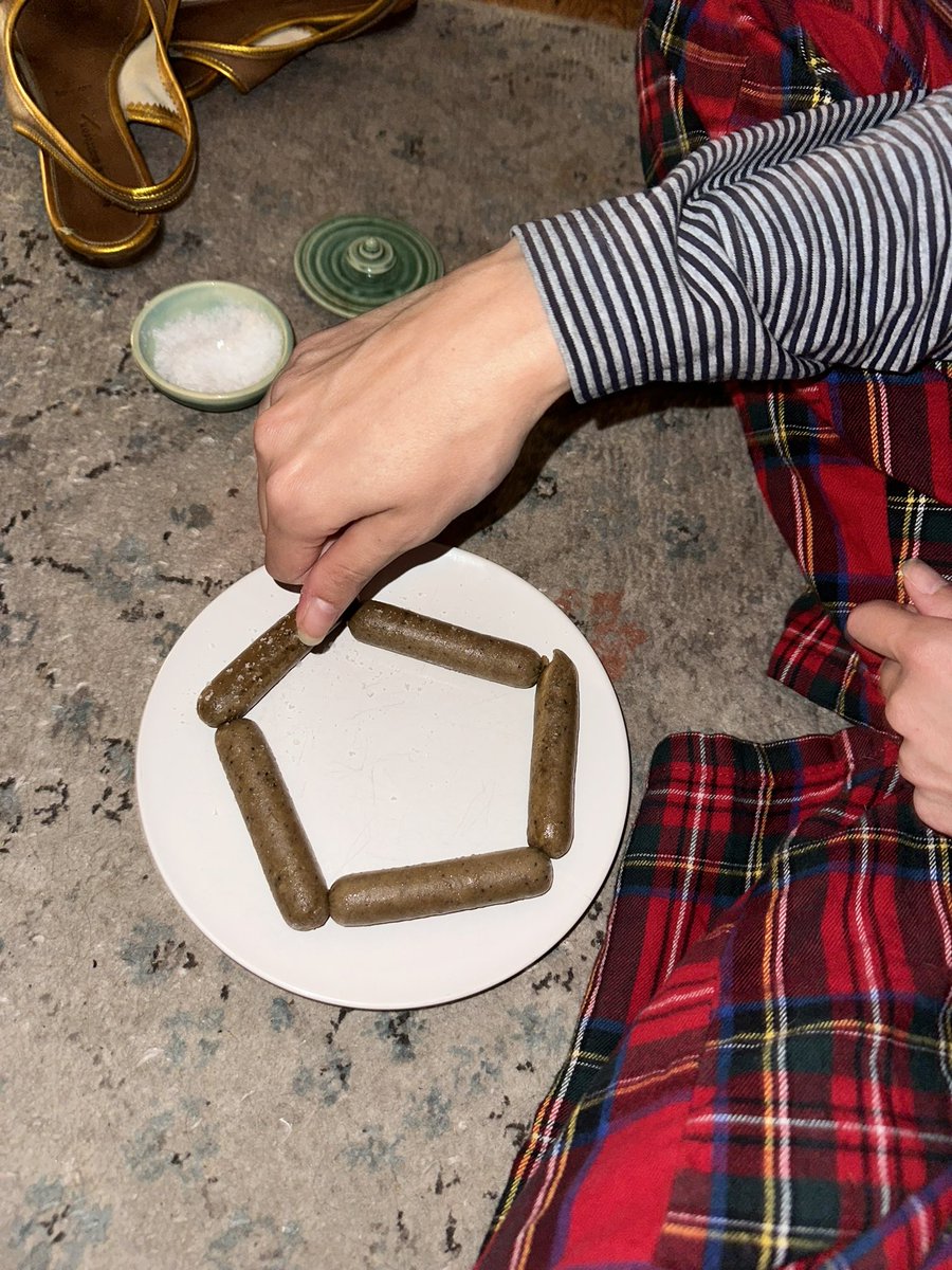 Gf eating a pentagon of sausages at midnight