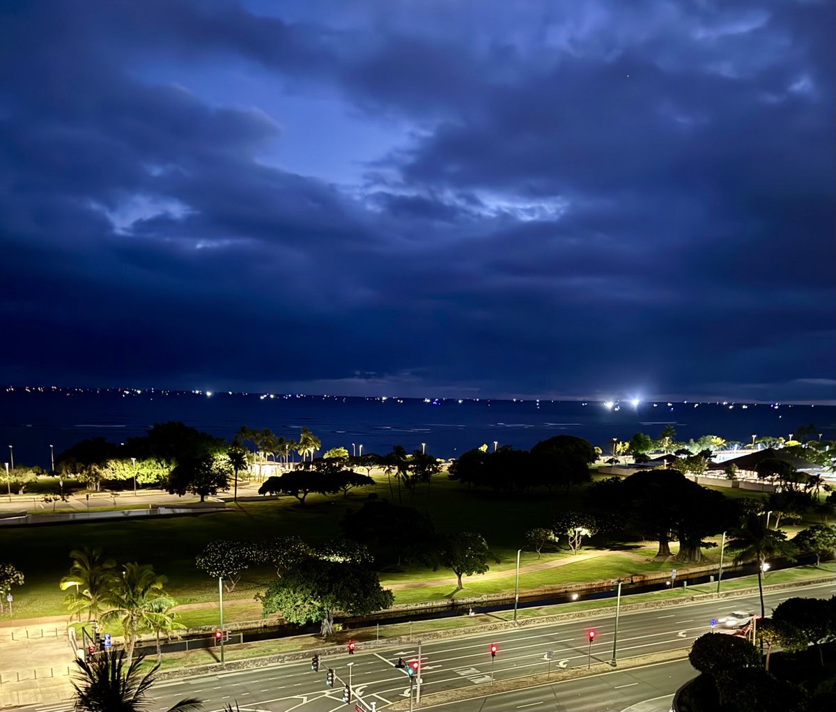 SuzanneNakano's tweet photo. The horizon off #Hawaii glows with ship lights — each one anchored in safety, far from shore.
A hauntingly beautiful pause before the unknown.
#Tsunami #HINews #HawaiiStrong #OceanWatch https://t.co/H5iVerB0dF