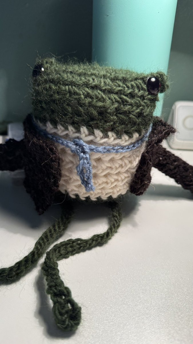 My daughter crocheted a little frog with a vest, tie, and removable fancy overcoat for my husband for his birthday