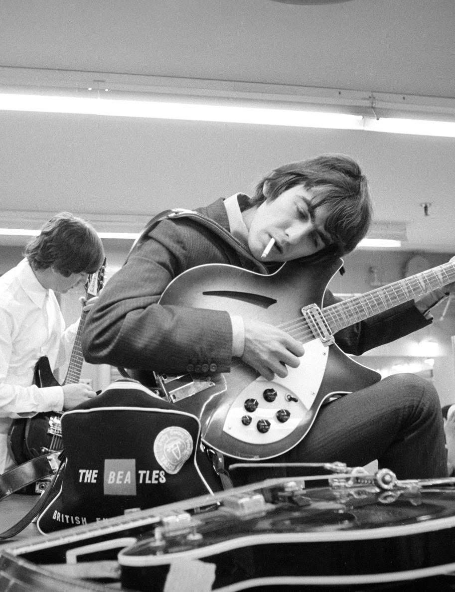 Tuning their Rickenbacker guitars. You’ve got to love the adapted British European Airways bag.