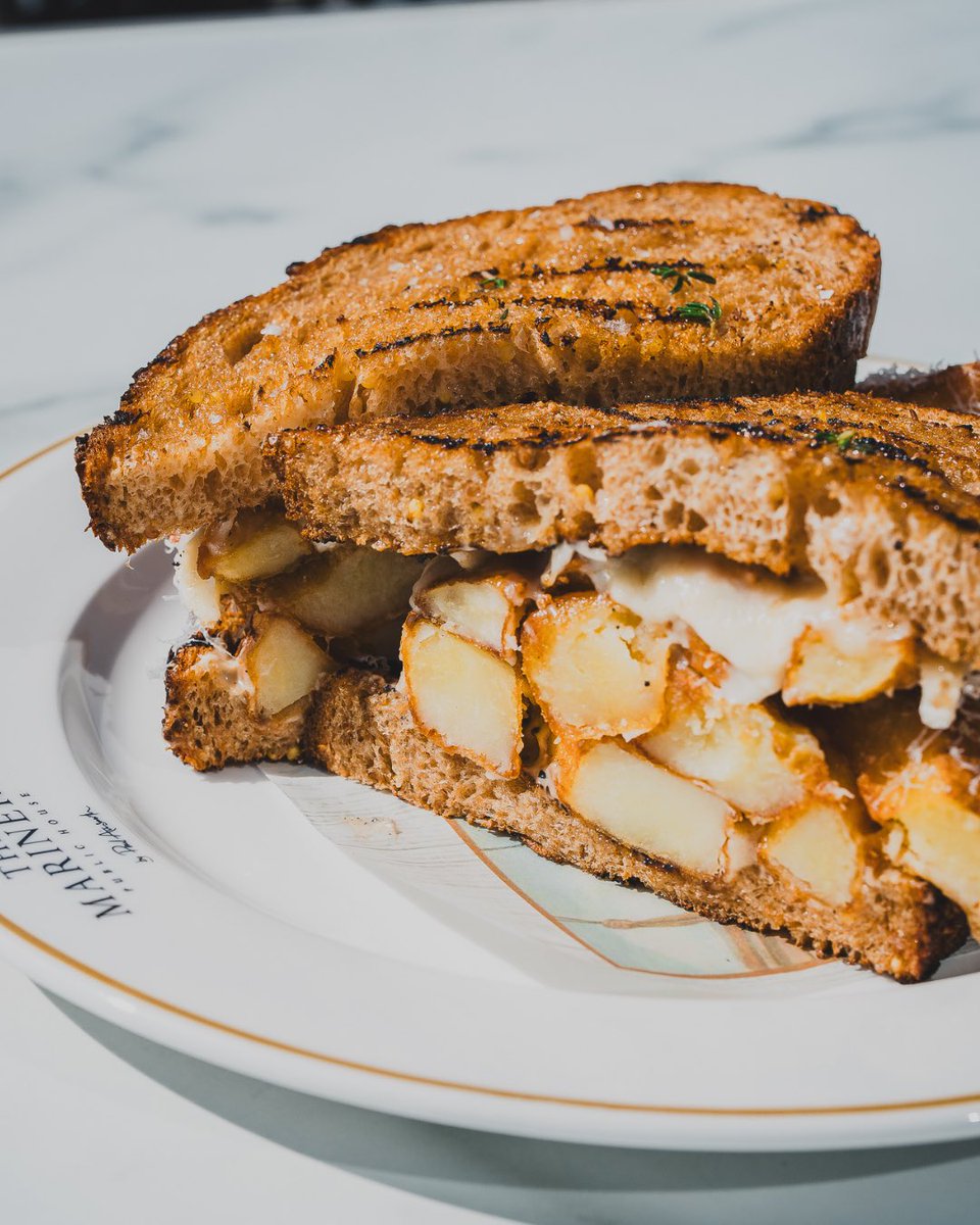 The Rock chip butty - a rainy day essential at The Mariners. Triple-cooked Yukon Gold chips, melted Cornish cheeses, truffle mayo, and toasted rye sourdough.