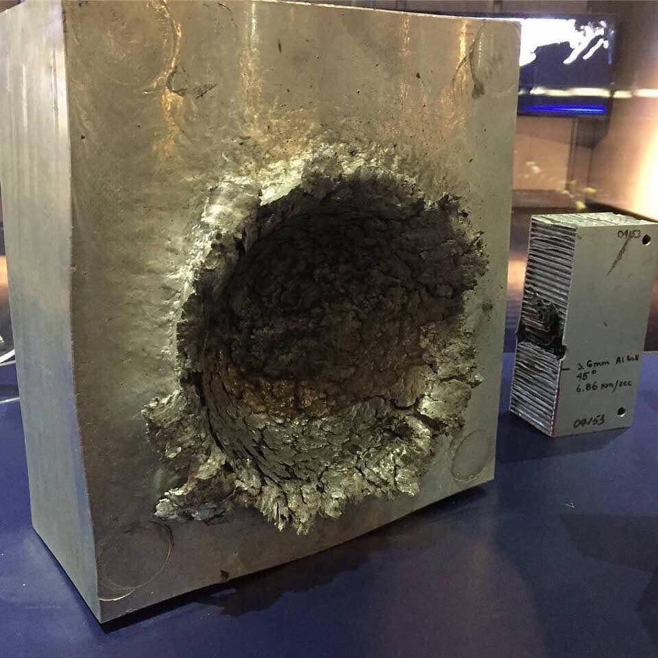 This is what happens to aluminium when a 1/2 inch piece of plastic makes contact at 24,140 km/h (15,000 mph) in space.