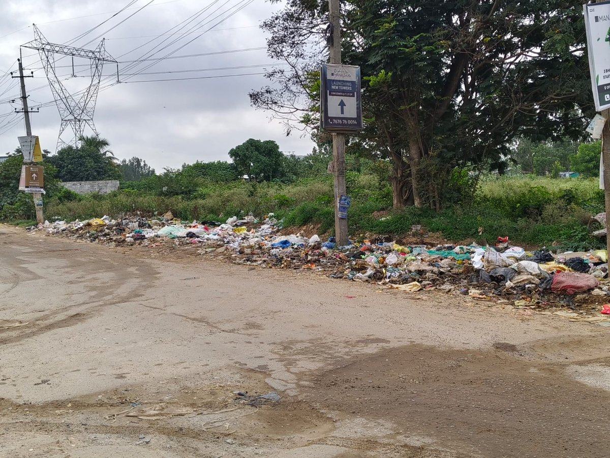 irfandear's tweet photo. There’s a serious garbage issue near Notre Dame School, Choodasandra,piles of waste left uncollected for days. It's attracting stray animals, spreading foul odors, and creating a breeding ground for disease. Children walk past it daily. Please take urgent action. @MLAShivanna https://t.co/r0ZGBOCvm1