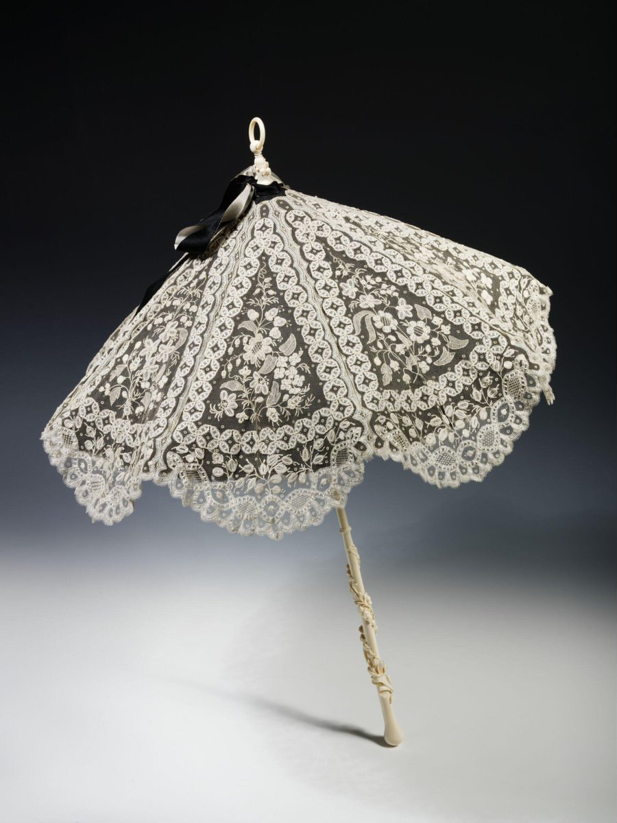 Parasol, 1870-1880, British; Applied lace on net, black silk, ivory handle. Victoria &amp; Albert Museum.
