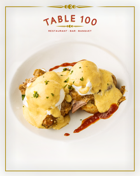 BBQ Benedict piled high with smoked pulled pork, poached eggs, and smoky tomato hollandaise on a buttermilk biscuit-  now that’s how we do brunch in the South.