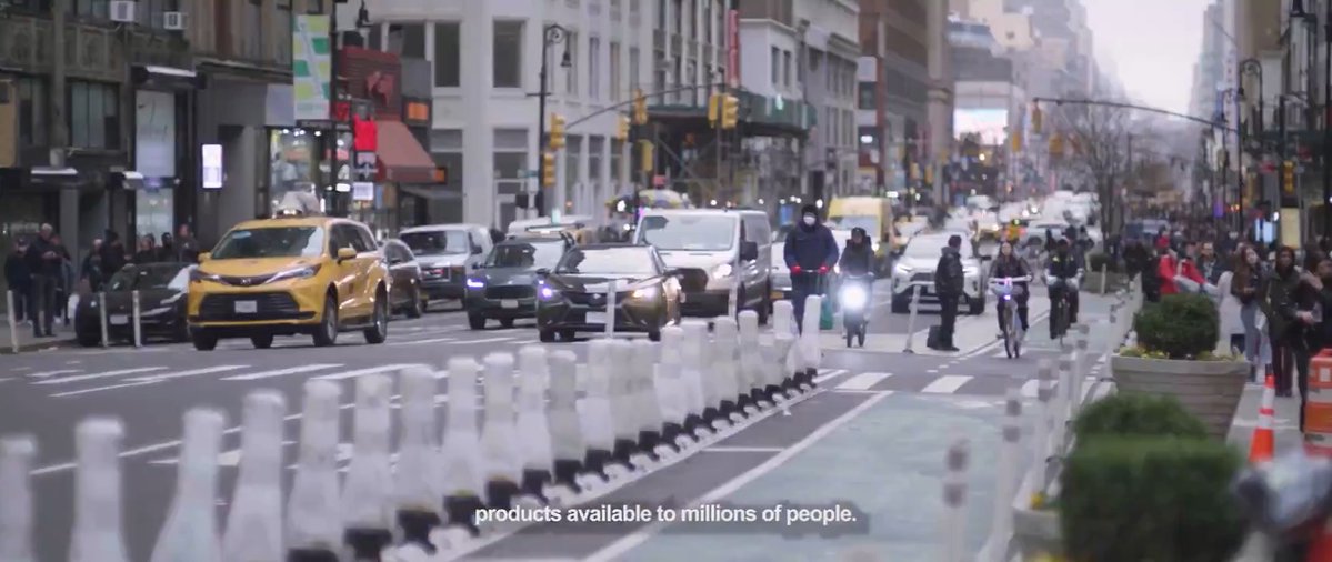 Busy city street with text overlay: 'products available to millions of people.'