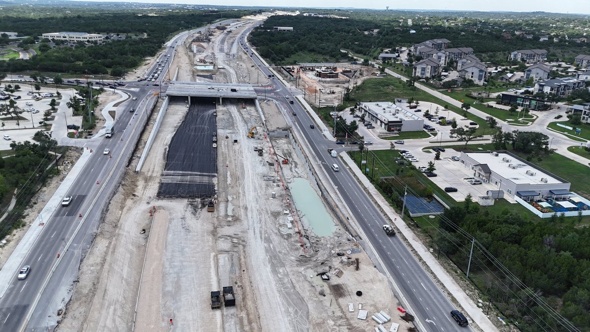 OakHillParkway's tweet image. Along the future eastbound US 290 mainlanes near RM 1826, crews place a thin layer of asphalt—known as a bond breaker. This critical step sets the stage for upcoming work like concrete paving. 🚧 #settingthestage