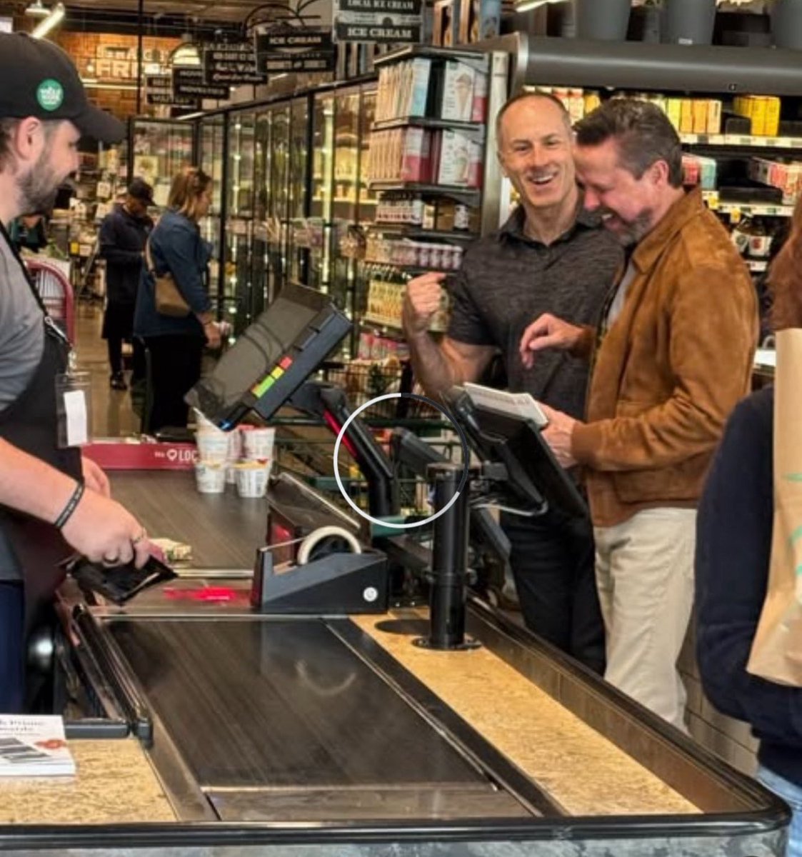 Back story:  mid-trial, AJ and I independently ended up at the Whole Foods in the South End.  I brought my stuff up to a register, preoccupied in my own thoughts, and didn’t pay attention to the guy in front of me in line while I loaded some yogurts onto the conveyer.  I then