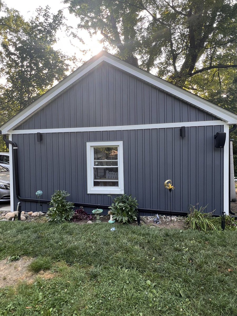 This Ridgewood home received new vinyl Dutch lap to the 2nd floor, vinyl cedar shake to the kitchen bump out &amp; modern board &amp; batten vertical panels to garage. Natural Slate color, white soffits &amp; fascia then black gutters &amp; downspouts brings out the sections of this home.