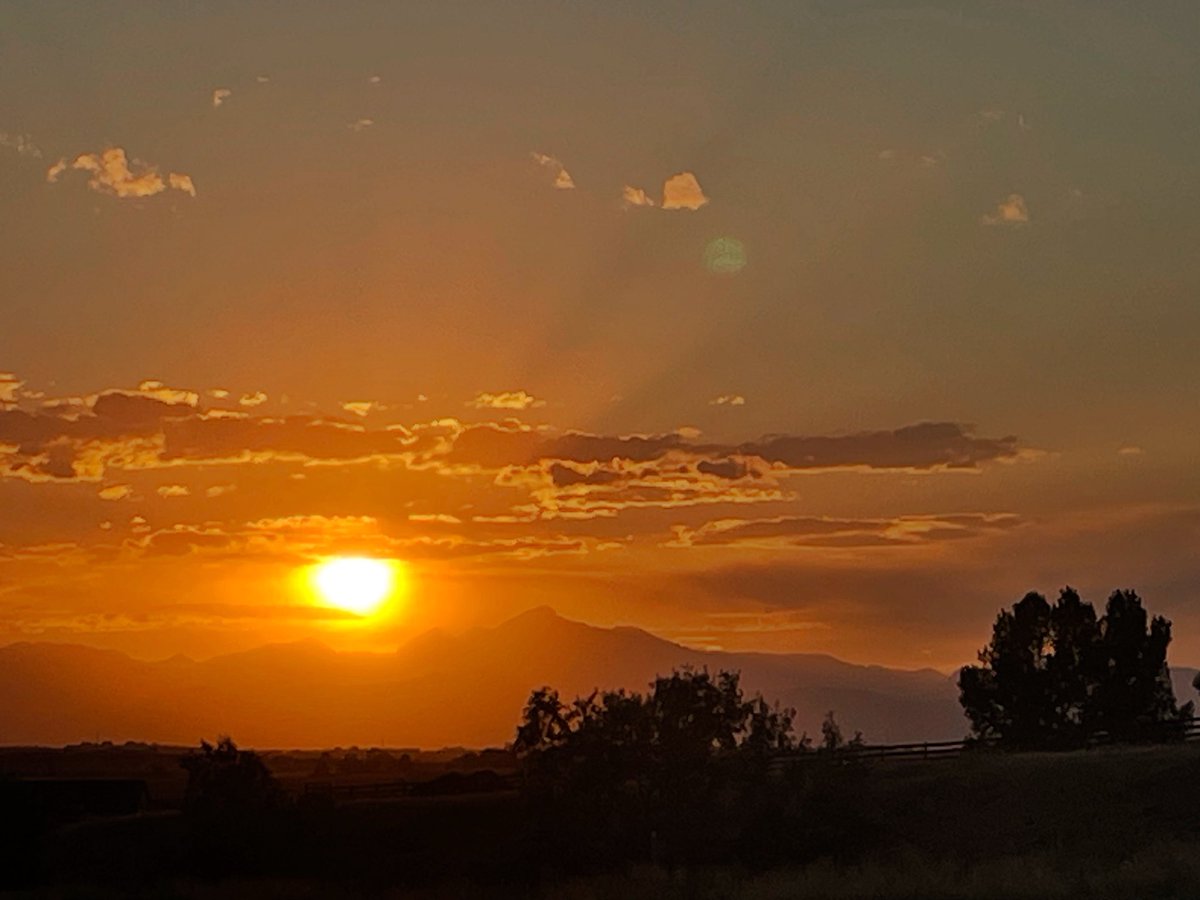 Sunset with the Denver airport behind us as we headed out to Boulder. The iPhone camera darkens it since you’re shooting into the sun. The sky was much bluer than this.