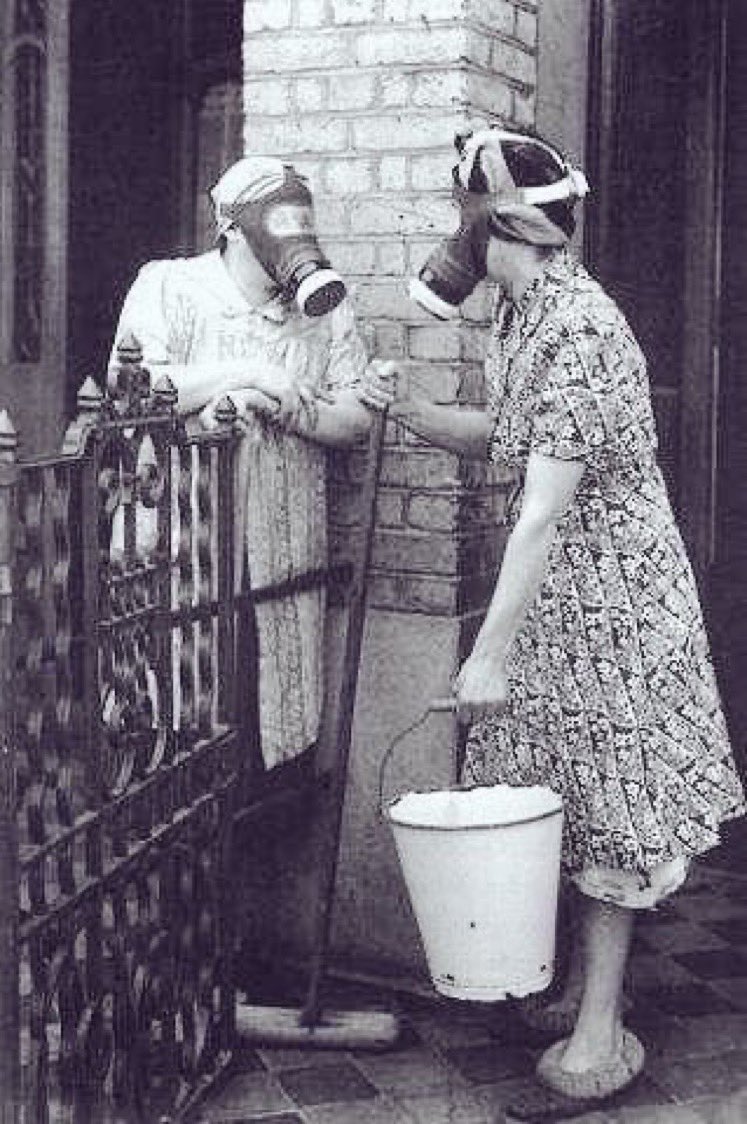 PHOTO OF THE DAY. Neighbours in London have a chat while wearing gas masks during the Blitz (1940). 📷 google images
