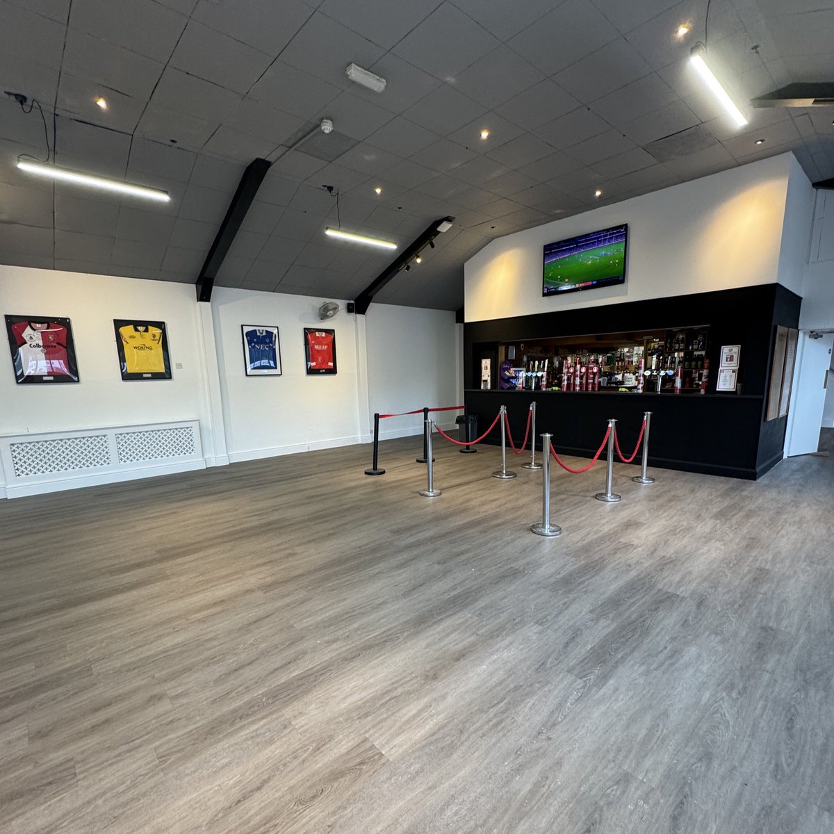wokingfc's tweet photo. The Club is delighted to share the results of our summer redevelopment of the Cardinals Bar! 

The modernisation of the bar allows for a more enjoyable match day experience for home fans, as well as allowing the club to host additional events. 

A big thank you to all of those who helped with the upgrade, including C&A Contracts, who installed new flooring and will sponsor the first team training bibs for this season.
