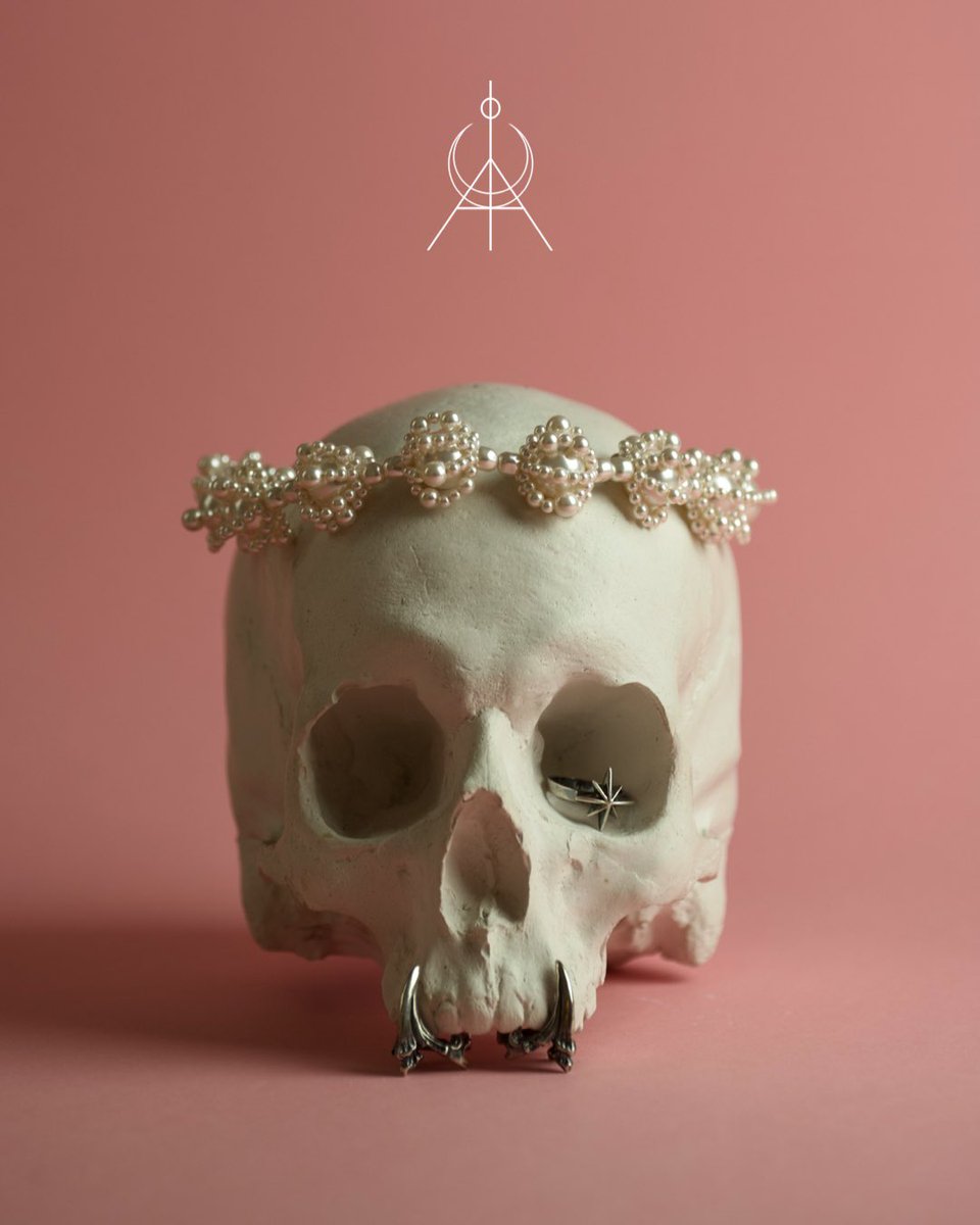 This is your #macabregadgets summer fever dream served iced, dripping in pearls and wrapped in cold silver.A moonlit martini in a coral sky world where skulls wear pearls and hot city is melting in a peachy glaze. #fashionjewelry #skullring #sirencore #summerjewelry #pearljewelry
