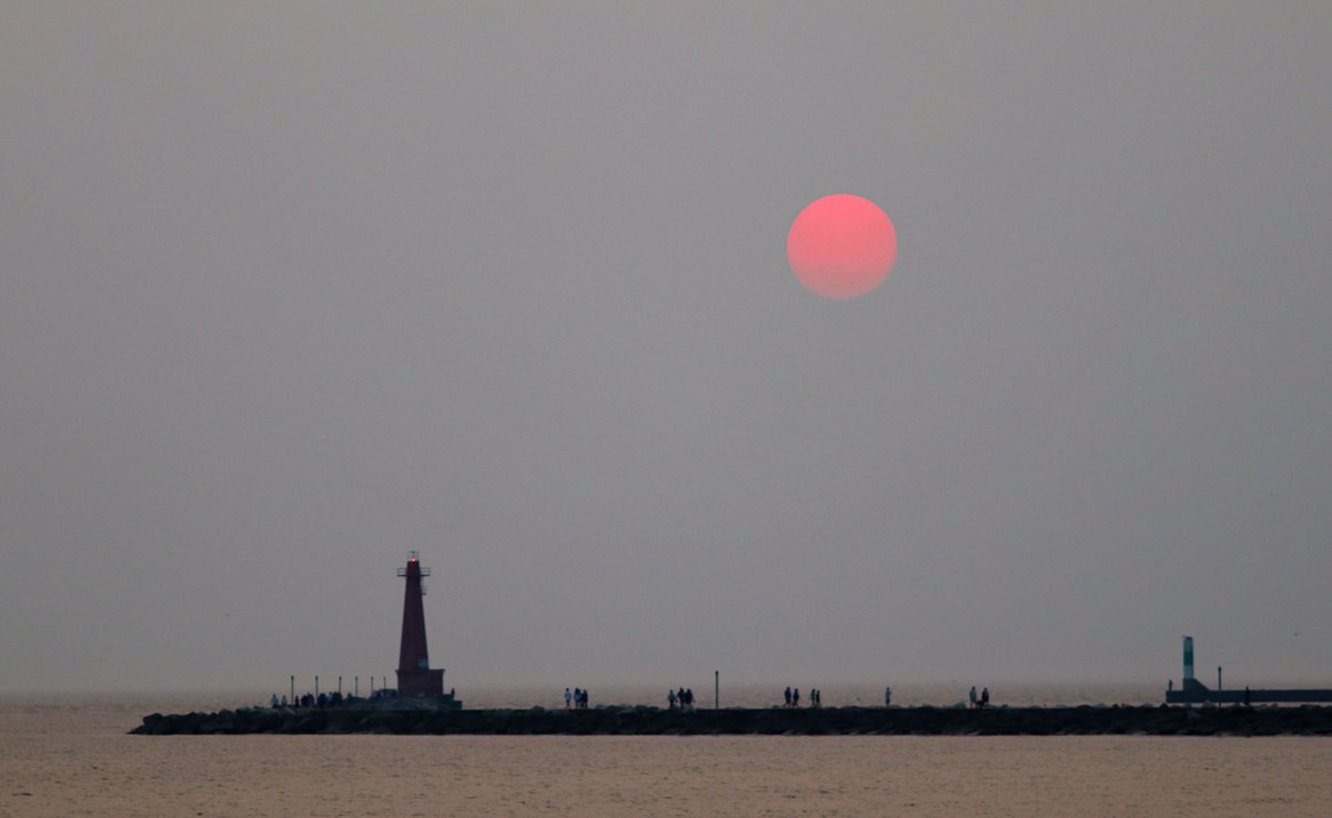 Canadian wildfire smoke has created an eerie haze and fiery red ball for a sunset this evening on the beach. Photo August 2, 2025 Muskegon’s Pere Marquette beach on Lake Michigan #sunset #weather #WildfireUpdate