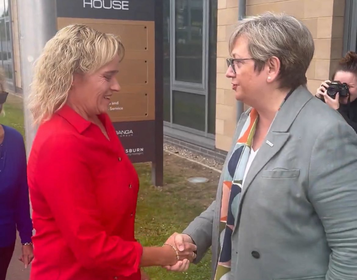 Here is Joanna smiling and shaking Sandie Peggie’s hand, *the morning after* the reports about Peggie’s racism were exposed.