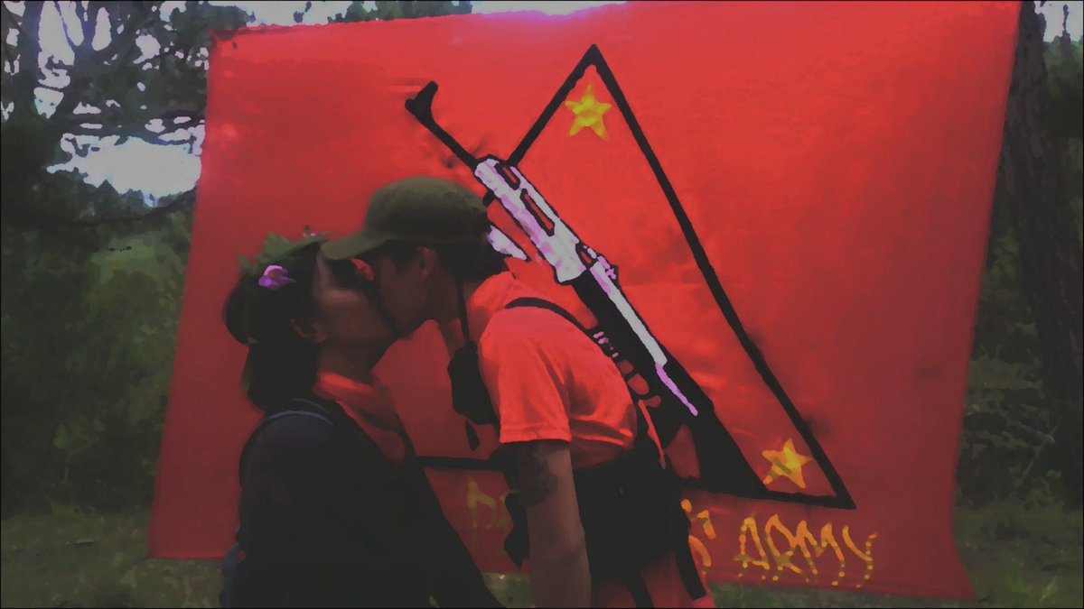 Two communist comrades getting married in a guerrilla camp in the Philippines.