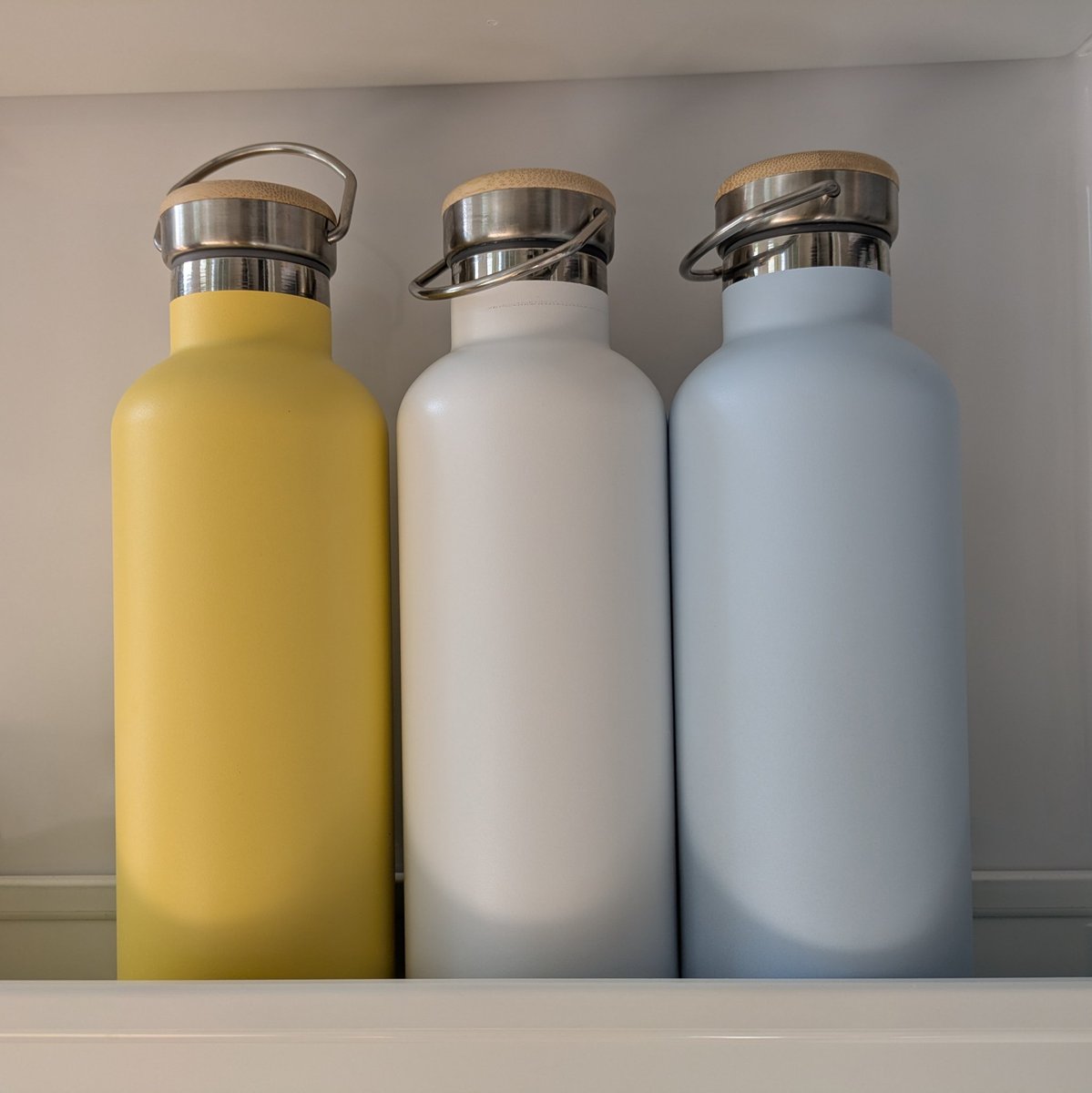 I refill orange juice, milk, and water into these steel bottles. Which one contains water, and which one contains milk?