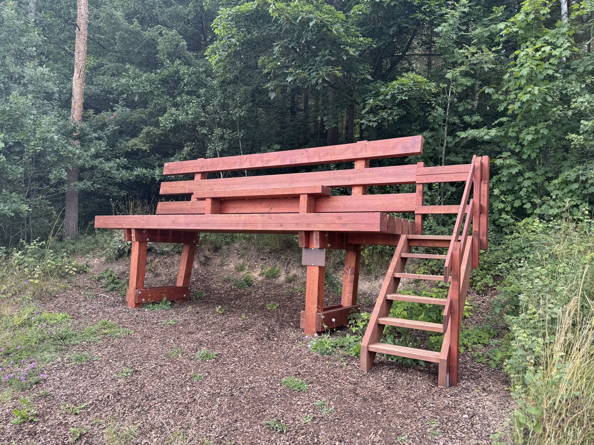 A big bench with a small bench on it, or, a small bench on a big bench.