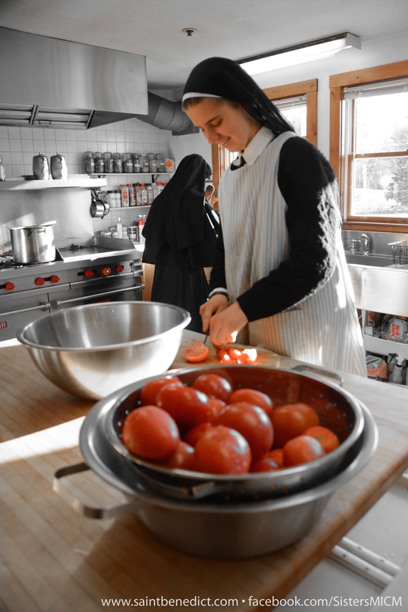 Sister Clare of the Slaves of the Immaculate Heart of Mary (MICM) in Still River, Massachusetts slicing tomatoes. Photo from the Sisters' Facebook page at facebook.com/photo?fbid=258….