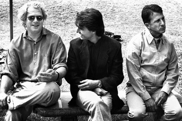 A behind the scenes photo of director Barry Levinson, Tom Cruise &amp; Dustin Hoffman on the set of RAIN MAN (1988).