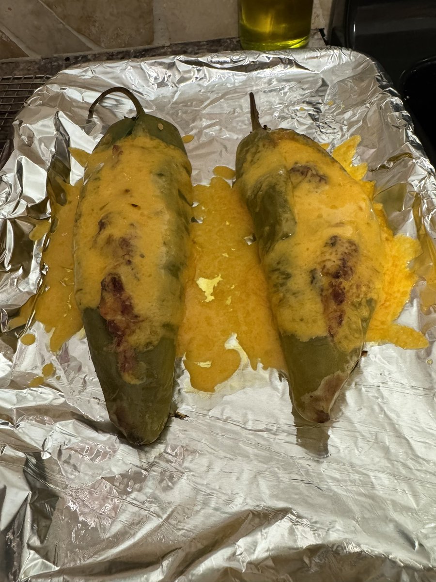 Trex530's tweet image. Hatch chili stuffed with pulled pork, cream cheese, chedder cheese, onions. Smoked for 1.5 hours. Then covered in cheese and hit with the broiler for like 5 min. 🤌🔥 served with a Bbq sauce sour cream. #smokedmeats #veggies #creamcheese #foodie