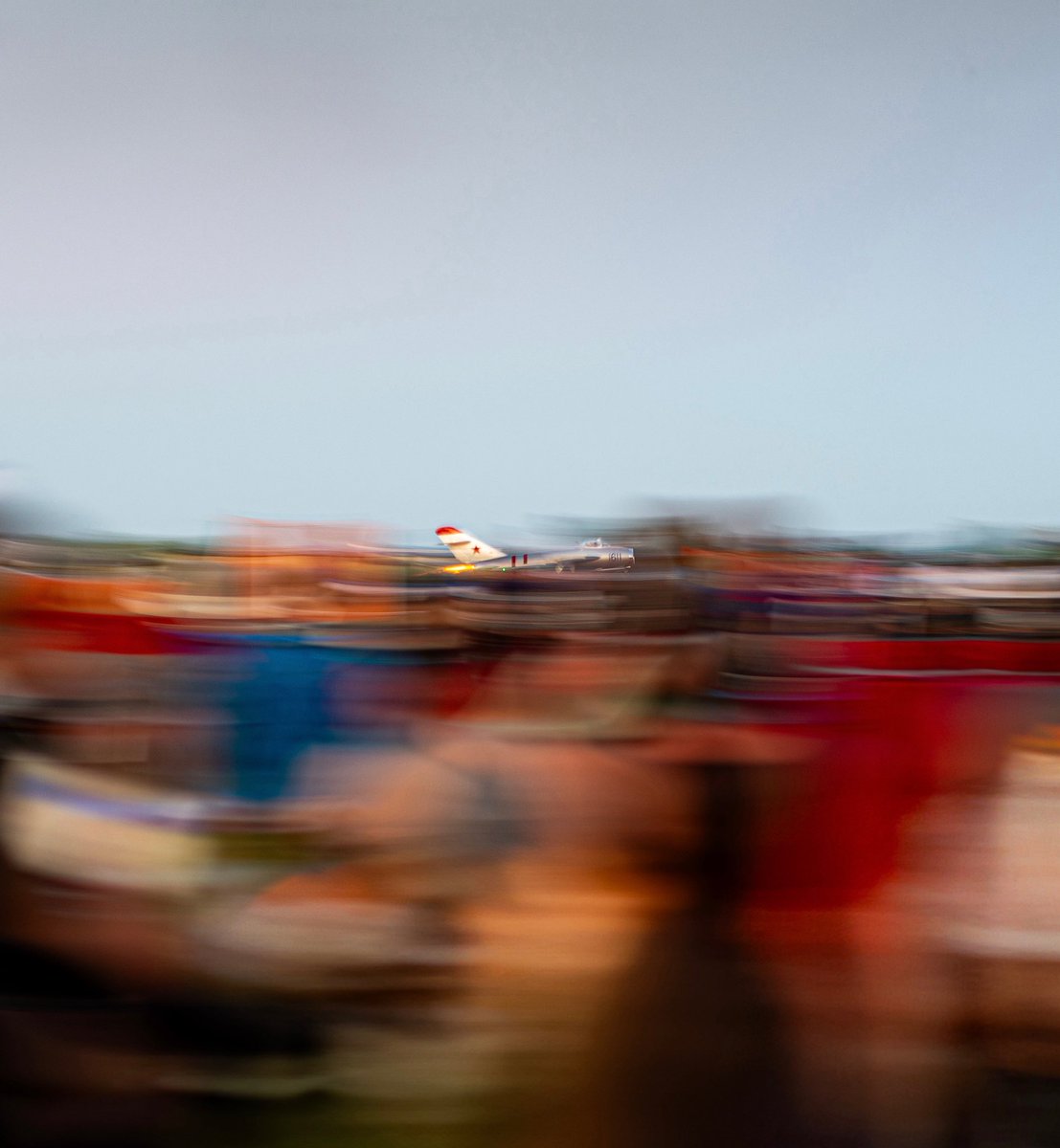 Randy Ball departs in front of a sea of people during the Saturday night show at EAA AirVenture 2025.