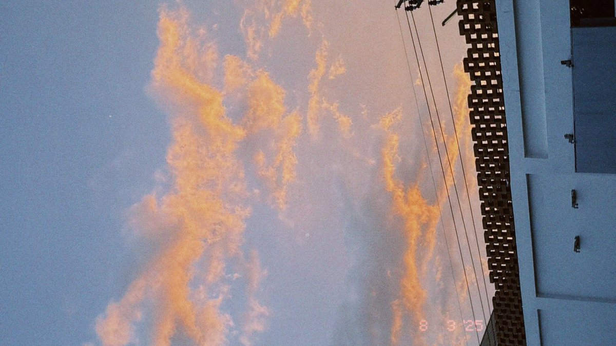 Yesterday’s sky sang in color—sunlight spilled gold on drifting clouds, brushing them with orange flame. Blue stretched behind like a quiet hymn. In that fleeting hour, the heavens whispered beauty, and the world paused to breathe in the glow of the afternoon.