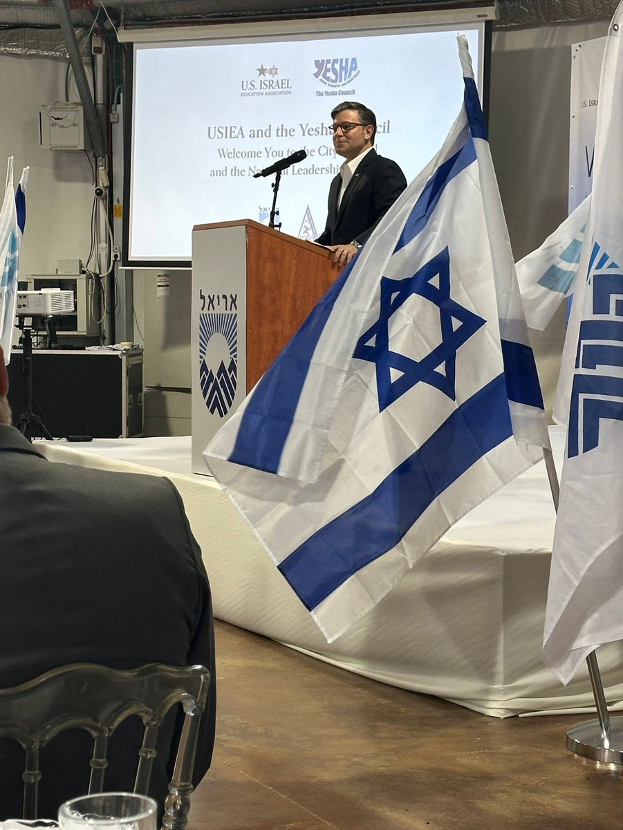 Your America First speaker of the house, Mike Johnson, ladies and gentlemen. Drenched in the flags of a nation committing genocide, standing in illegally occupied West Bank marked for annexation. Incredible.